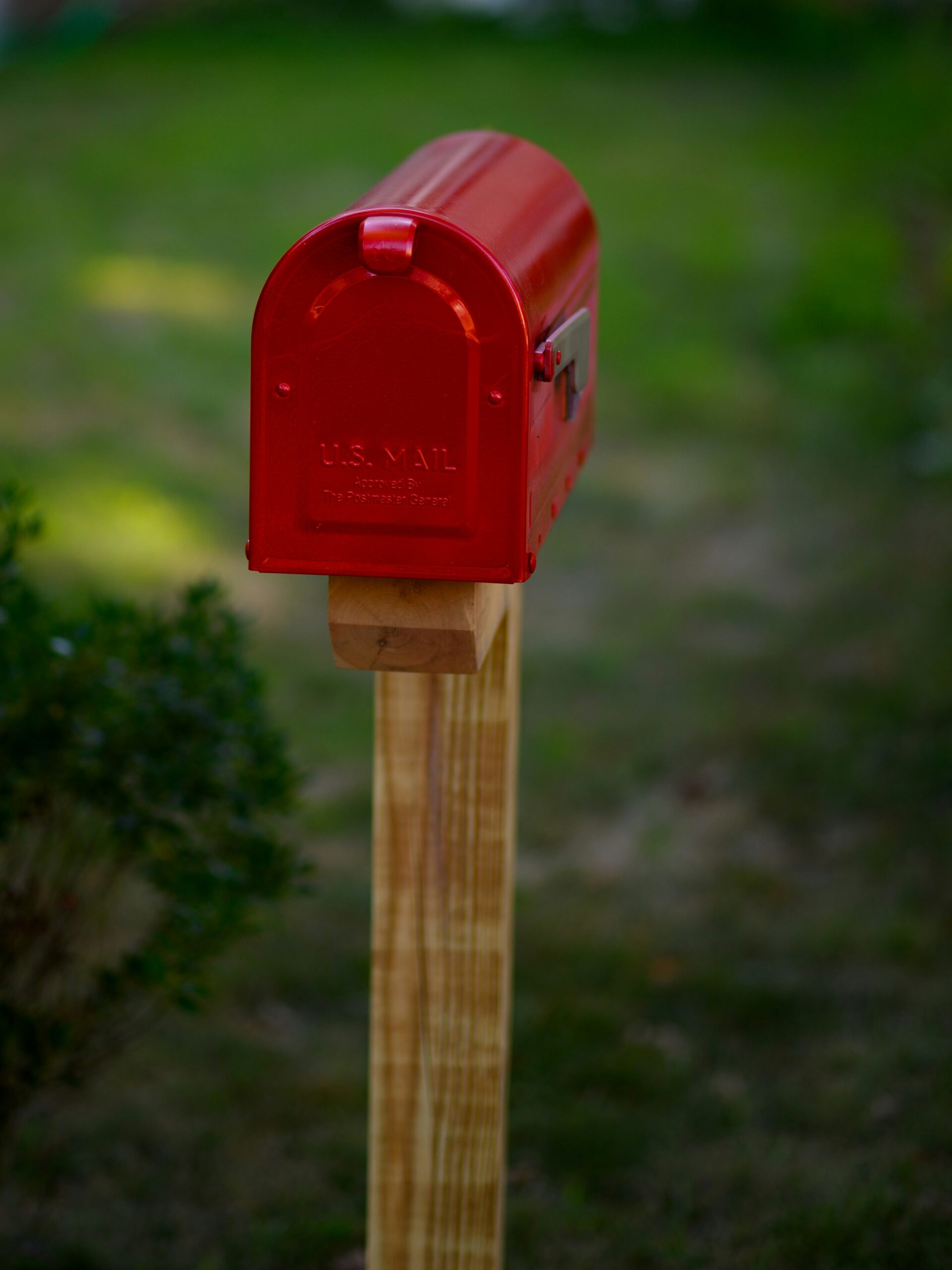 a red mailbox on a wooden post